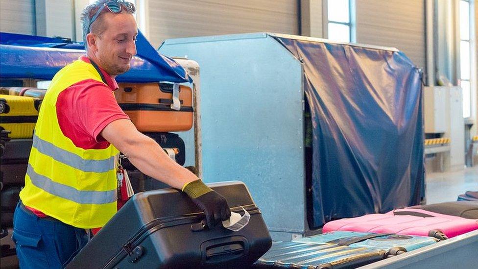 Stock image of man holding suitcase