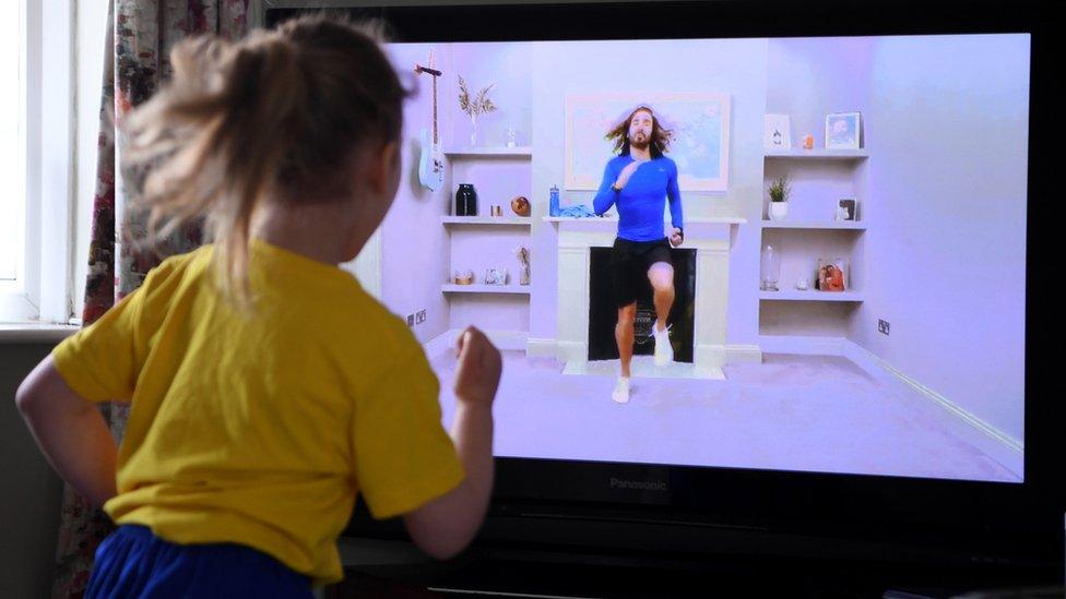 Child follows Joe Wicks' PE session