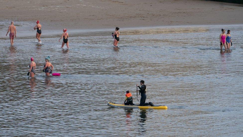 Swimmers close to the shore in Cullercoats on 30 March