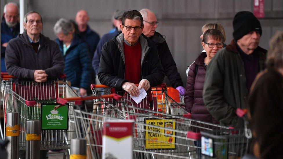 Shoppers queuing outside the entrance