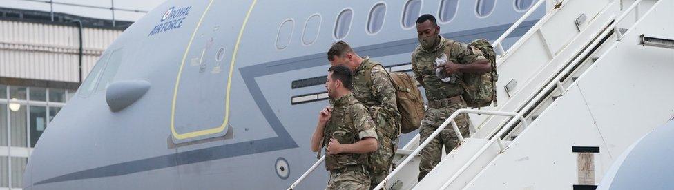 Members of the British armed forces 16 Air Assault Brigade exit the plane