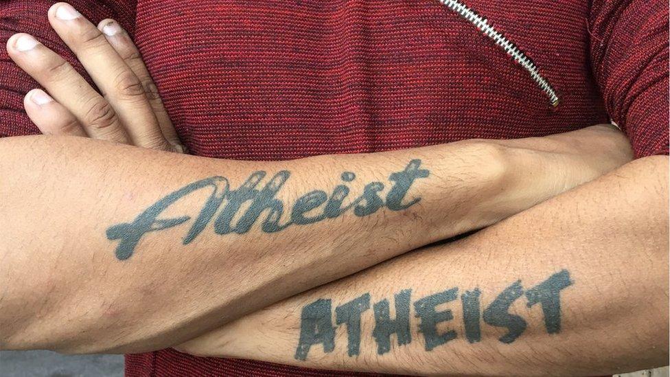 Ravi shows off his Atheist tattoos