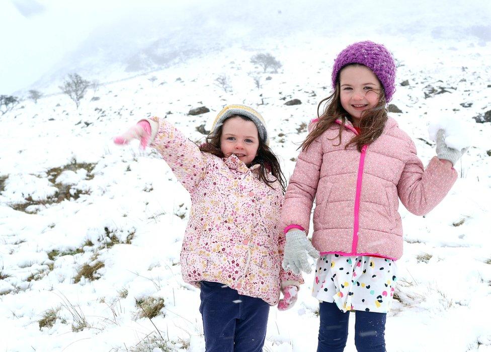 Two girls throw snowballs on Slemish Mountain