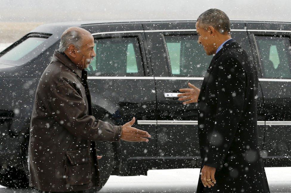 John Conyers (D-MI) (L) greets President Barack Obama as he arrives aboard Air Force One at Detroit Metropolitan Wayne County Airport in Detroit, Michigan January 20, 2016.