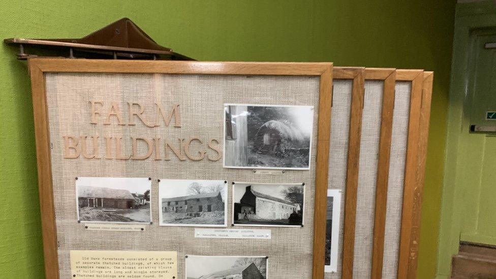 Display boards showing photographs of old Manx farm buildings