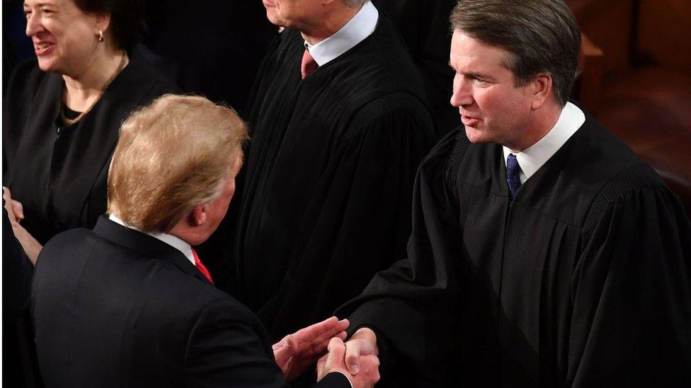 US President Donald Trump shakes hands with US Supreme Court Justice Brett Kavanaugh before delivering the State of the Union address