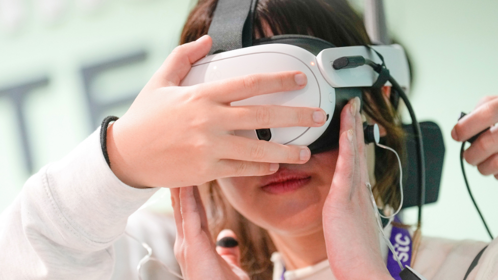 A woman with a VR headset on