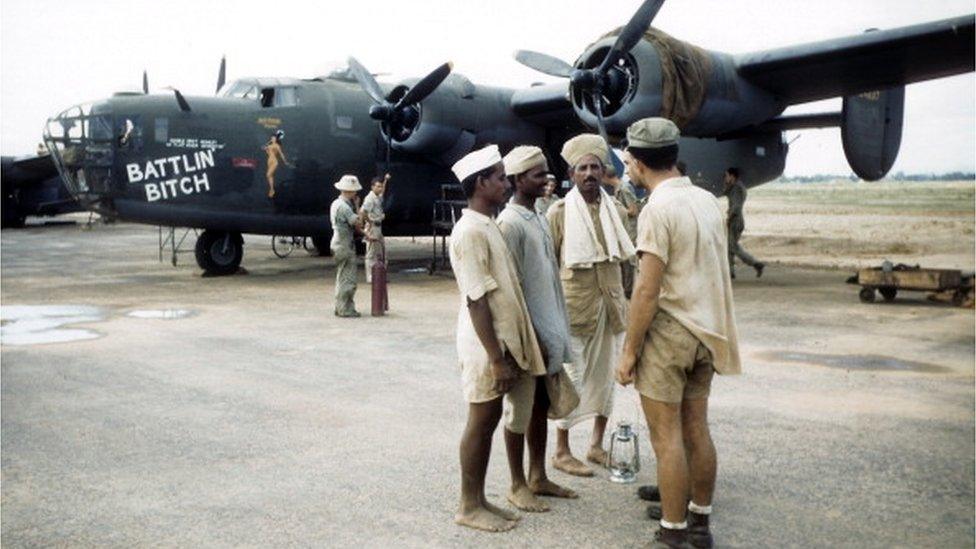 A soldier speaks with local officers at the U.S. Air Force Base in Arga, India.