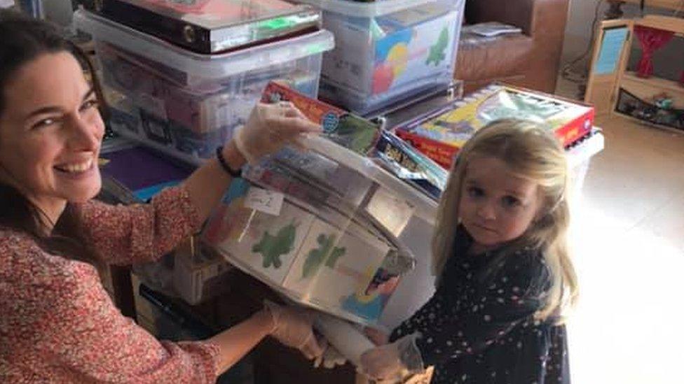 Laughlin's sister Eliza helps with the boxes