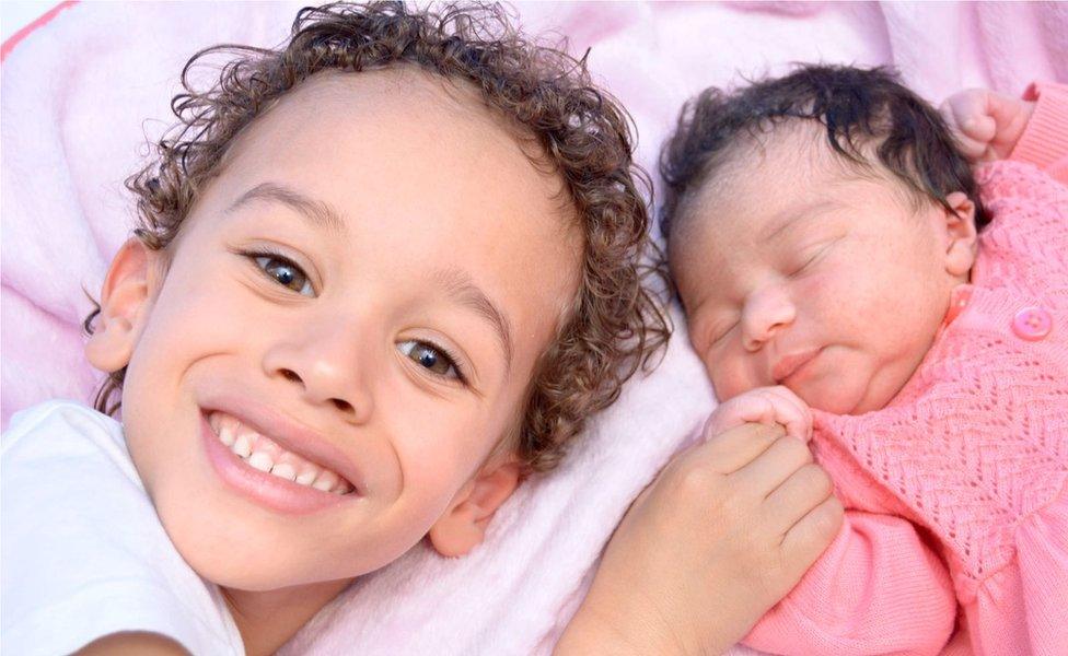 Alexander, 5, looking delighted to meet his day-old sister Miya born in October