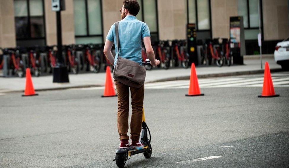 A man rides a scooter in Washington DC