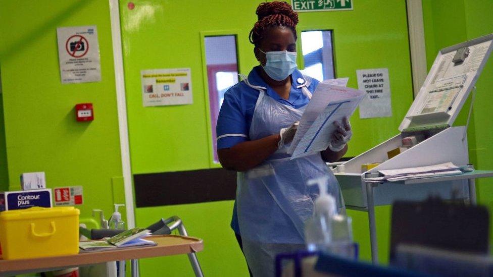 A nurse wears a face mask in Blackburn in May