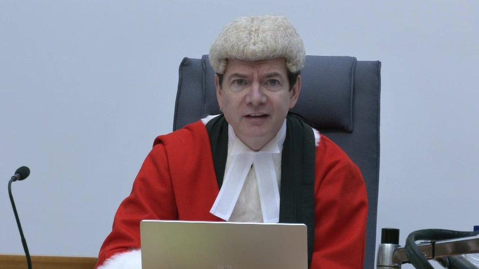 Still of Mr Justice Bryan speaking into a microphone while delivering his sentencing remarks at the hearing.