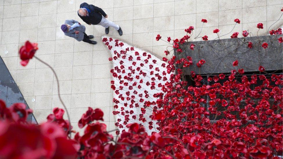 People look at the Weeping Window at the Ulster Museum