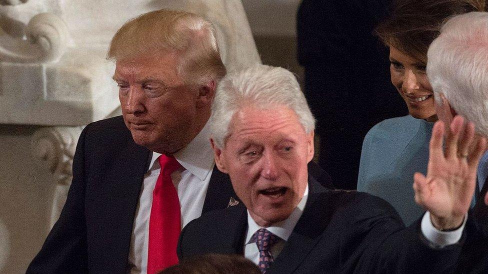 US President Donald Trump passes former President Bill Clinton at the Trump inauguration in Washington, January 2017