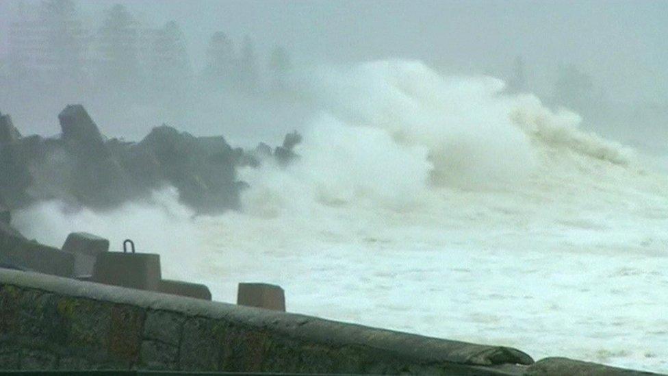 Waves crashing onto coastline