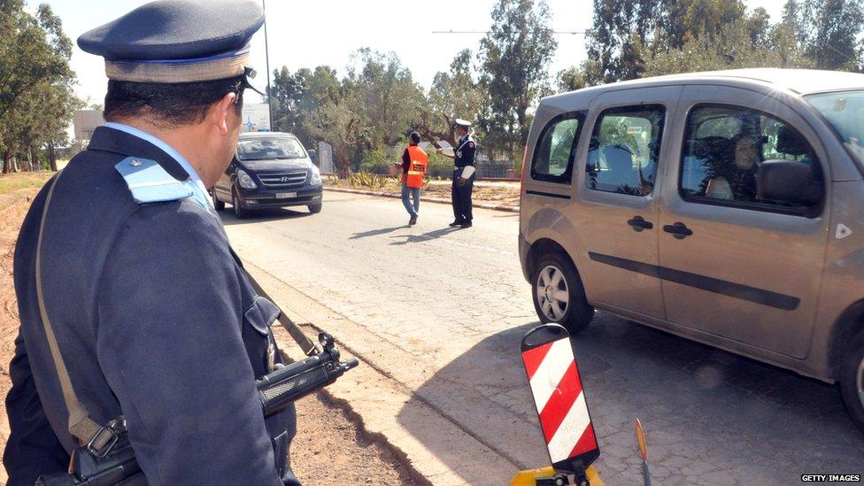 A police officer watches traffic in Marrakesh, 2011