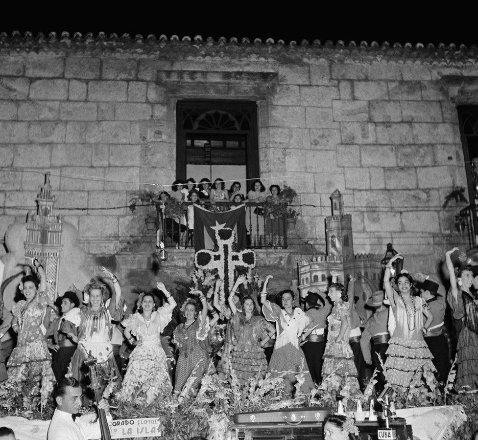 People gather in traditional costumes at the Havana Cathedral in Havana