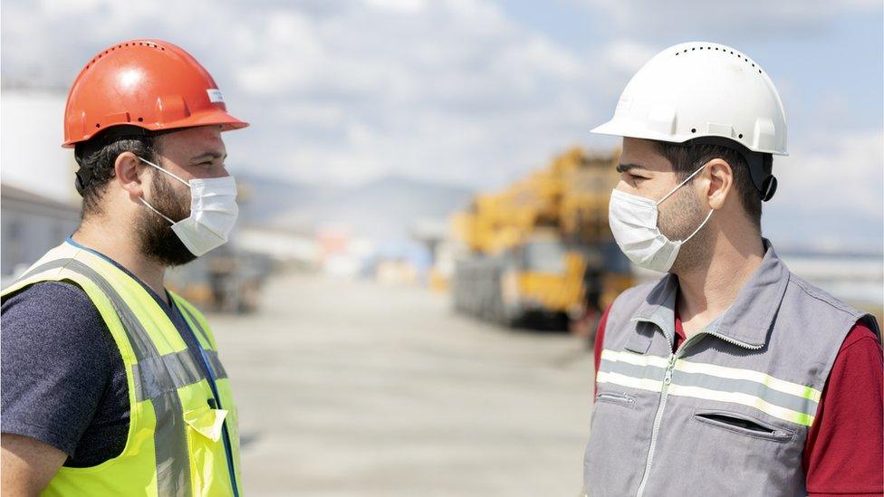 Construction workers in masks