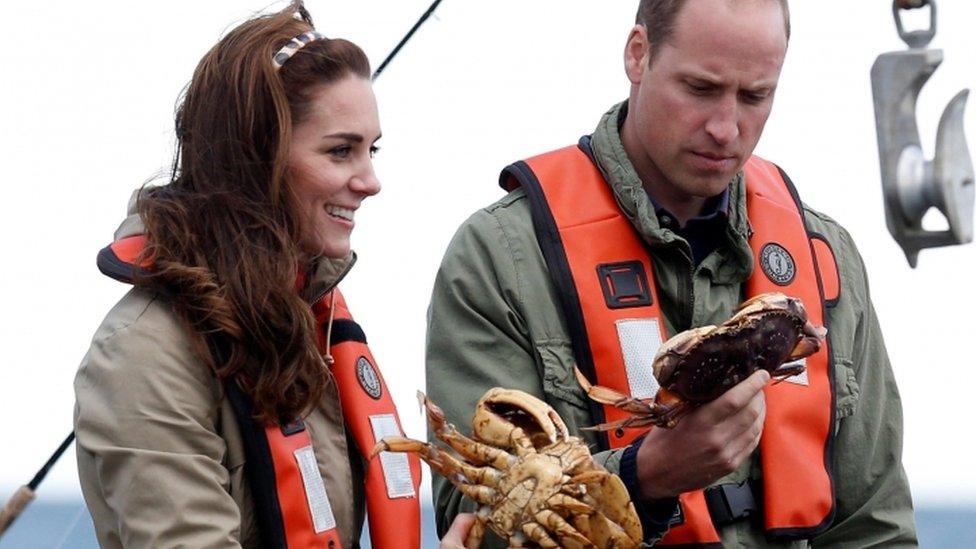 The Duke and Duchess of Cambridge holding crabs