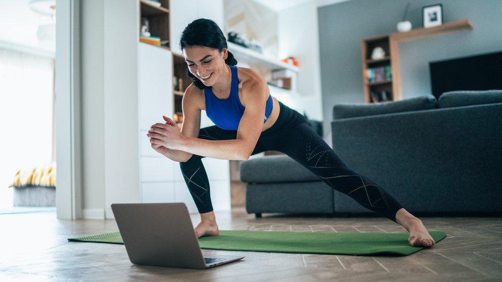 A woman leading a home-workout class