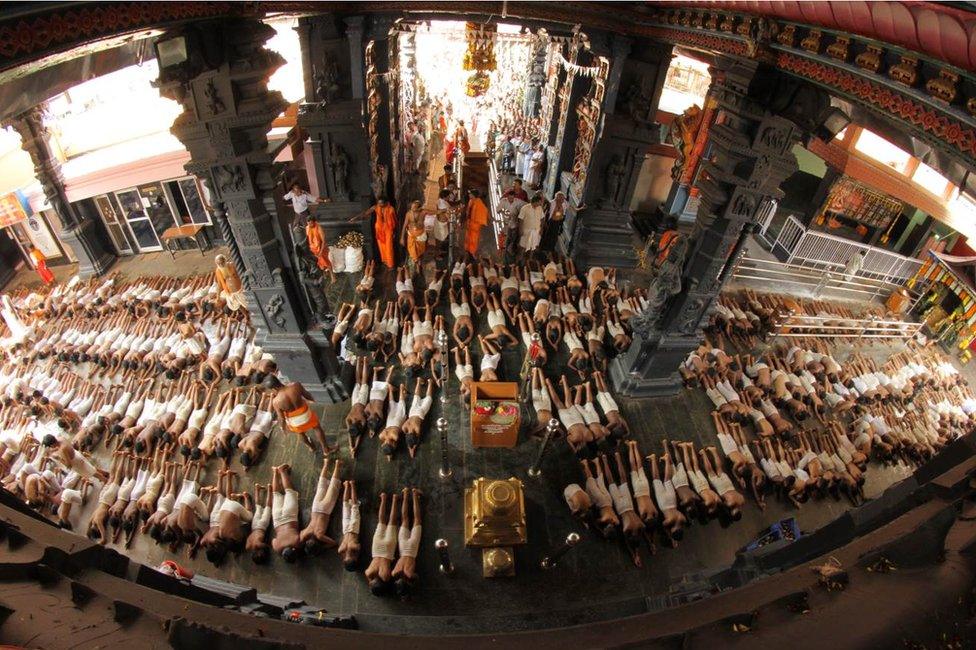 Children prostrating inside the temple.