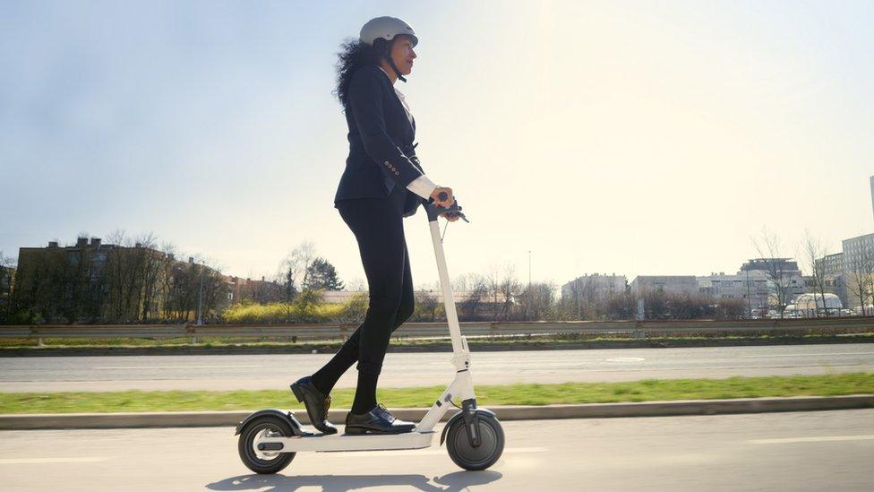 Woman riding an e-scooter