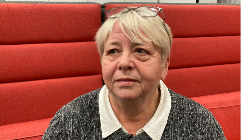 Wendy Buffrey is sitting down and facing slightly away from the camera