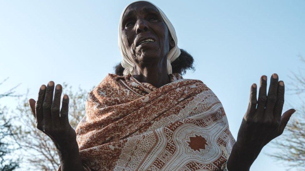 An Ethiopian refugee who fled the Tigray conflict prays during Sunday Mass at an Ethiopian Orthodox church building built by former Ethiopian refugees, at the village next to Um Raquba refugee camp in Gedaref, eastern Sudan, on December 6, 2020