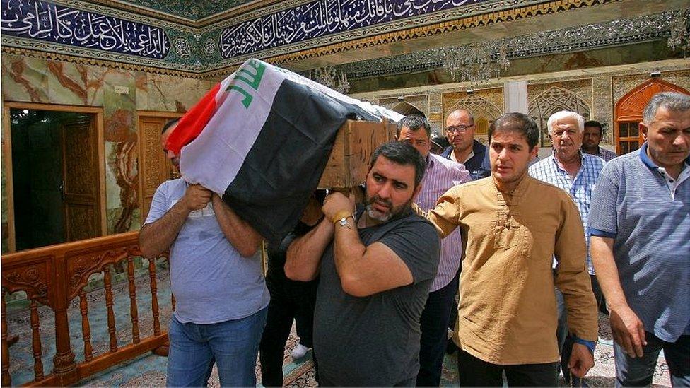 Mourners carry the coffin of a victim of bombing in Baghdad