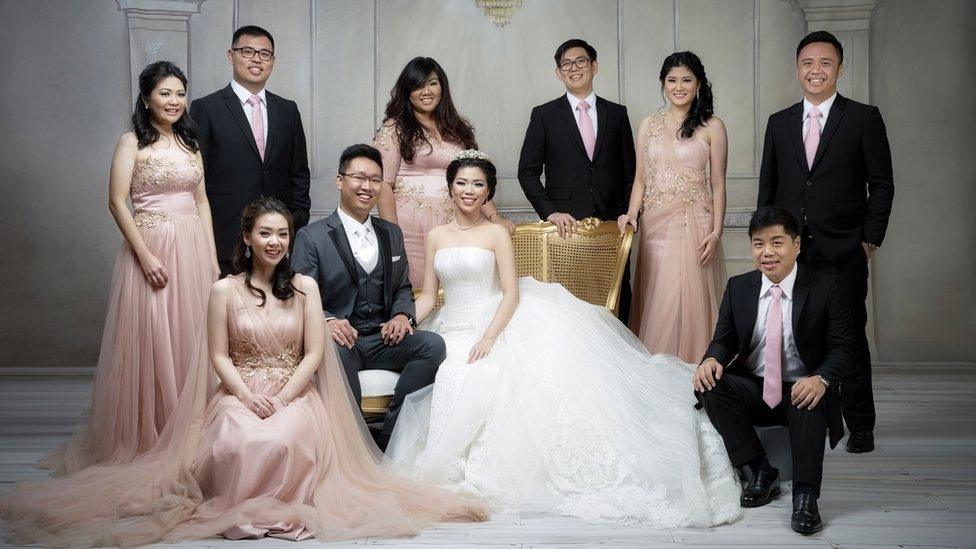 A family wearing rose gold-themed wedding outfits