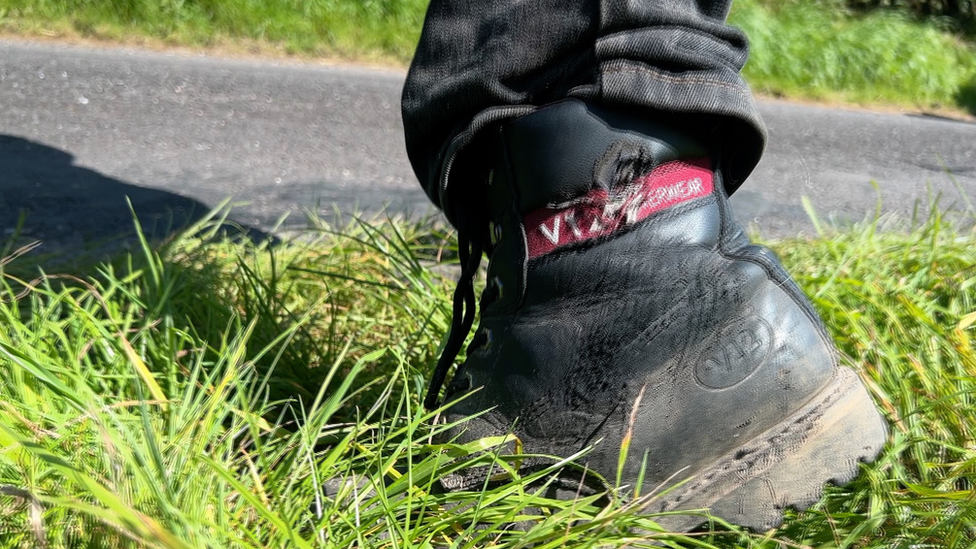 A farm worker's damaged boot