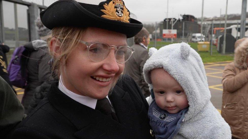 Sailor holding child