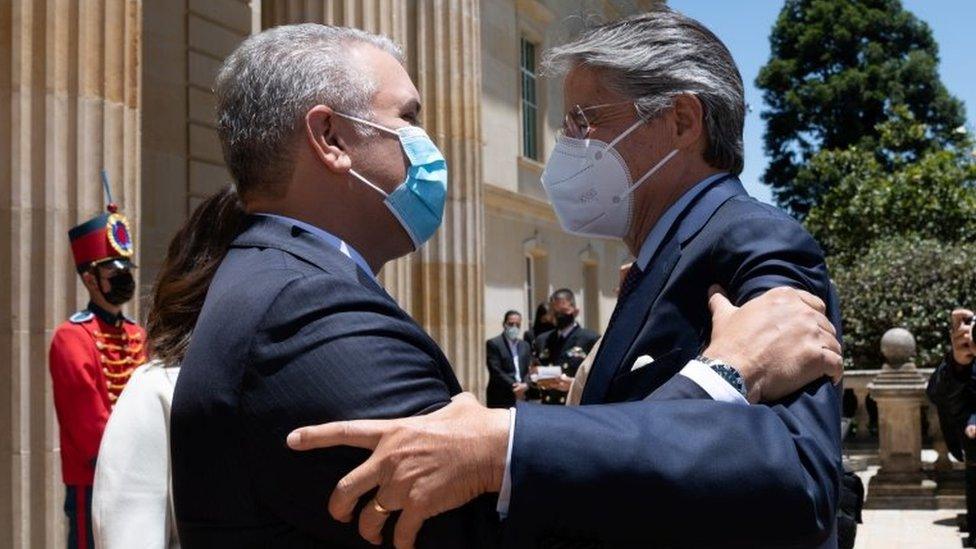 Colombia's President Ivan Duque and Ecuador's President-elect Guillermo Lasso embrace, in Bogota, Colombia April 20, 2021