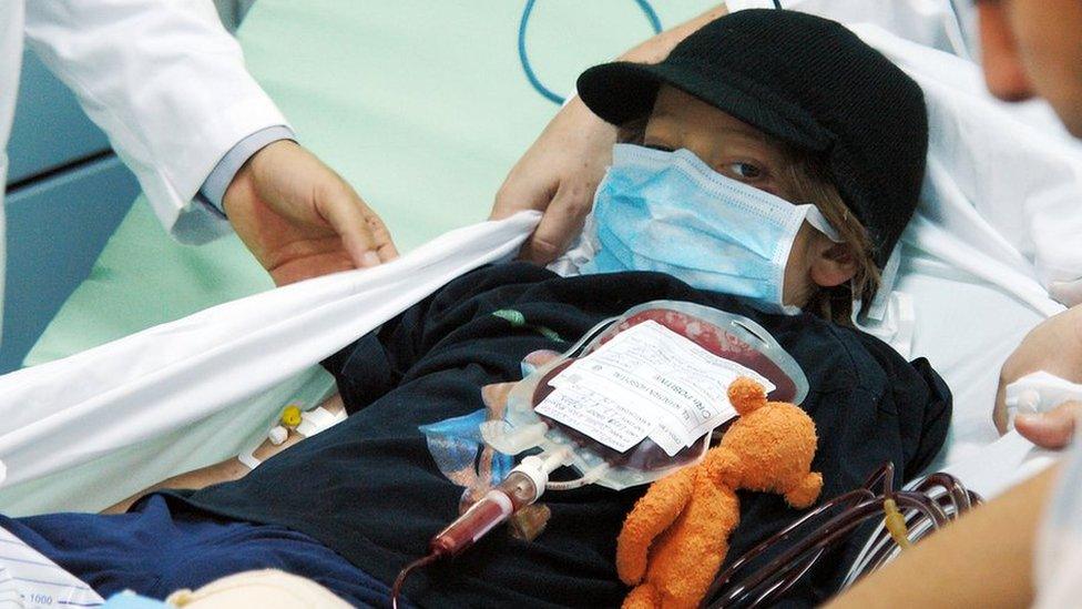 Libyan medics prepare to carry Dutch boy Ruben van Assouw as he leaves a hospital in Tripoli 15 May 2010