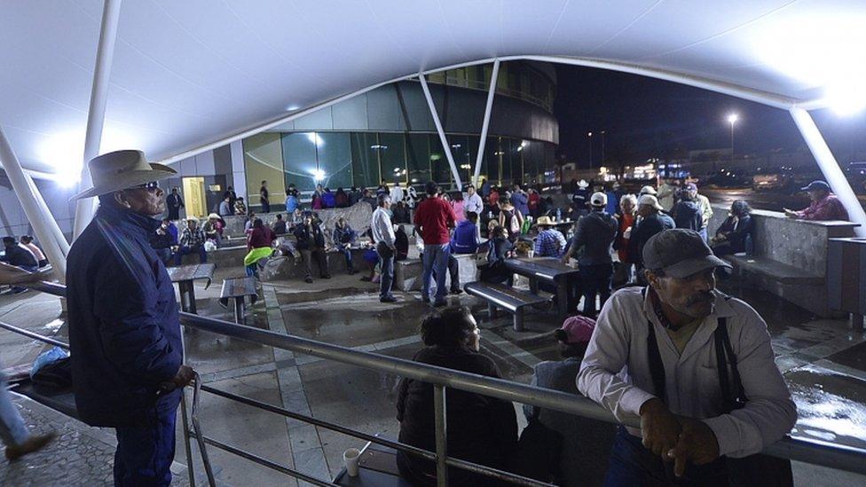 Relatives of passengers on the crashed plane wait for medical reports, outside a hospital in the city of Durango, Mexico, on 1 August 2018.