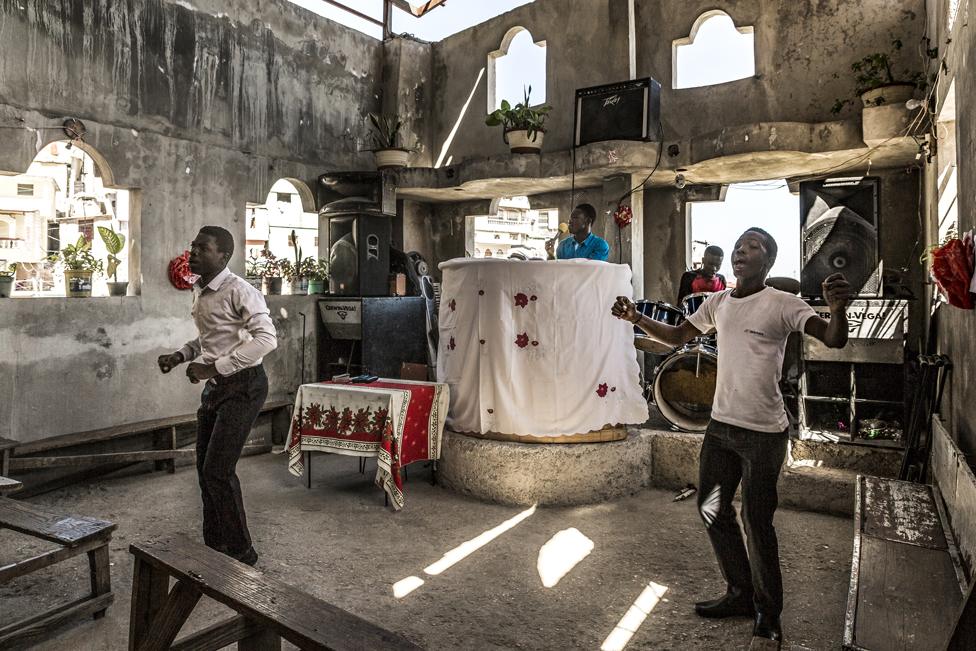 Churchgoers pray inside Eglise Evangelique Baptiste church