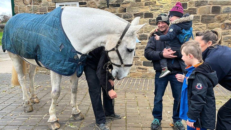 Ely and family with a police horse