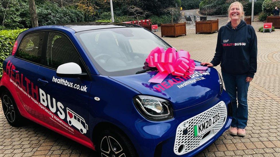 HealthBus car with a pink ribbon on the bonnet