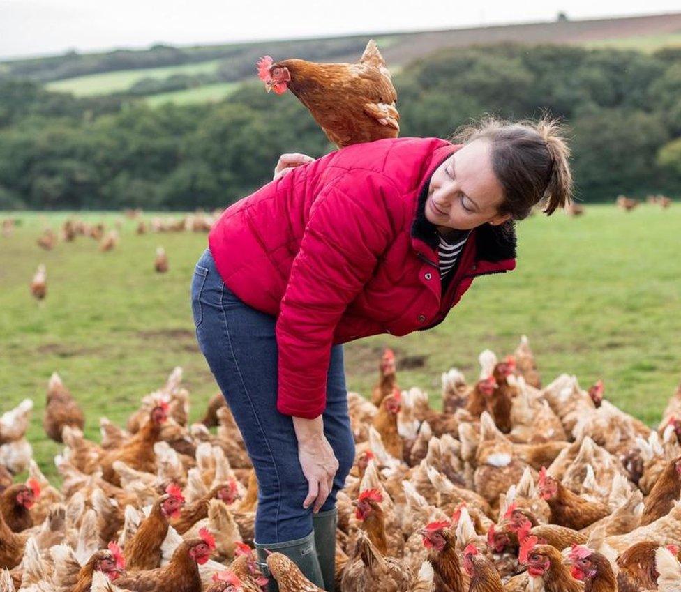 Bex Tonks surrounded by hens