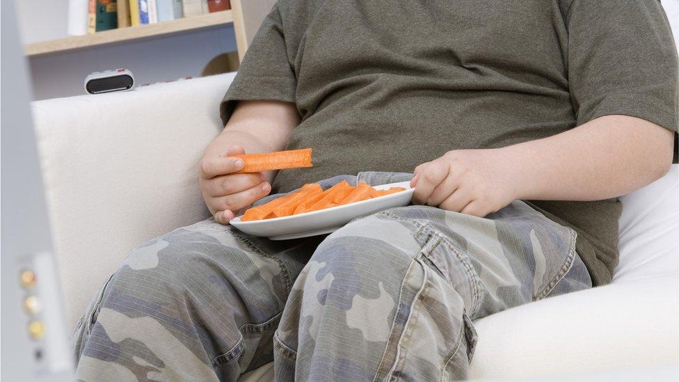 Boy eating carrot sticks