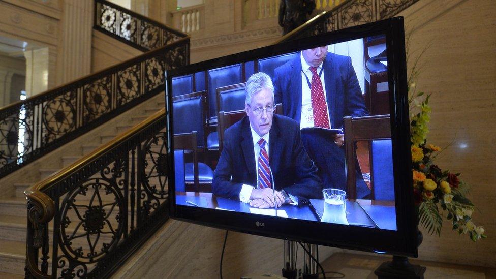 Peter Robinson appears on a television screen inside Parliament Buildings at Stormont