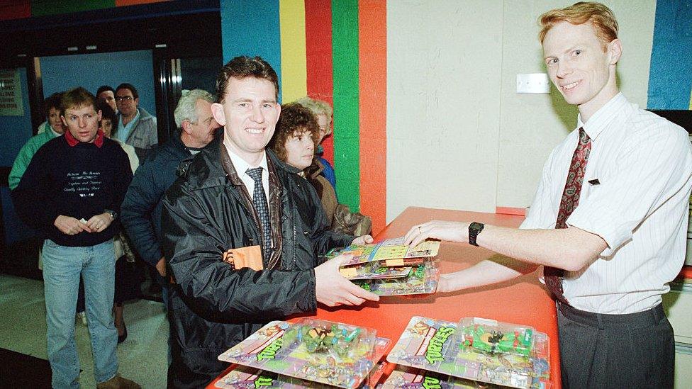 Toys R Us customer buying TMNT figures in Stockton on Tees, 1990