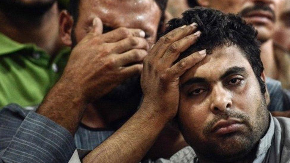 Relatives of killed Coptic Christians look on as they gather during the funeral at Abu Garnous Cathedral in the north Minya town of Maghagha (26 May 2017)