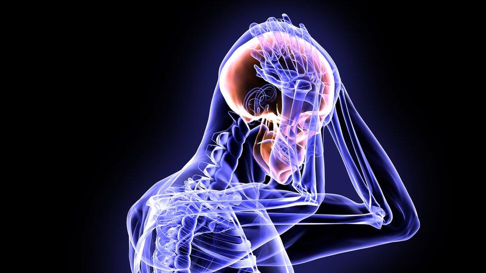 X-ray style graphic showing person holding their head