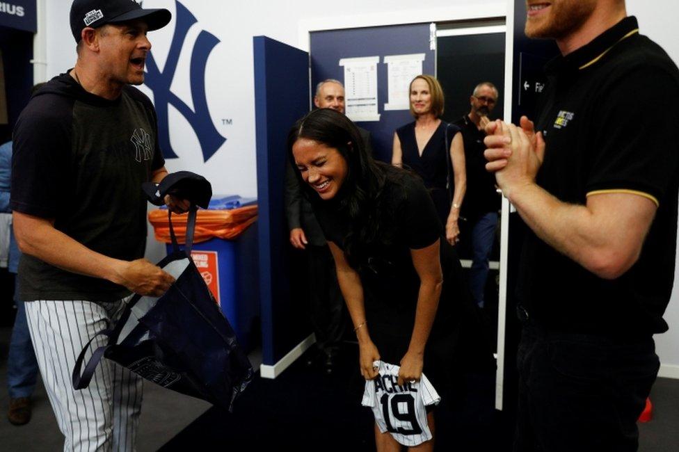 Meghan is all laughs as manager of the New York Yankees, Aaron Boone, presented her with a gift for Archie