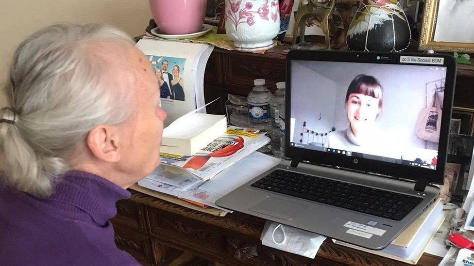 A French woman speaks to a student via video call