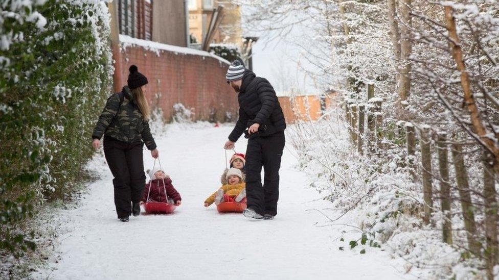 Families out and about enjoying fun in the snow in Cambuslang, Glasgow, Britain