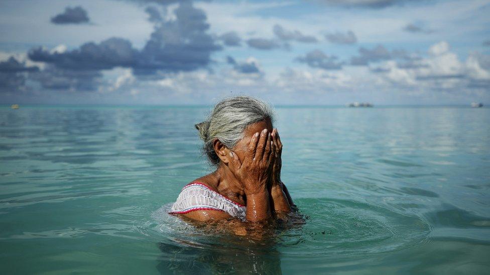 Woman sits in sea