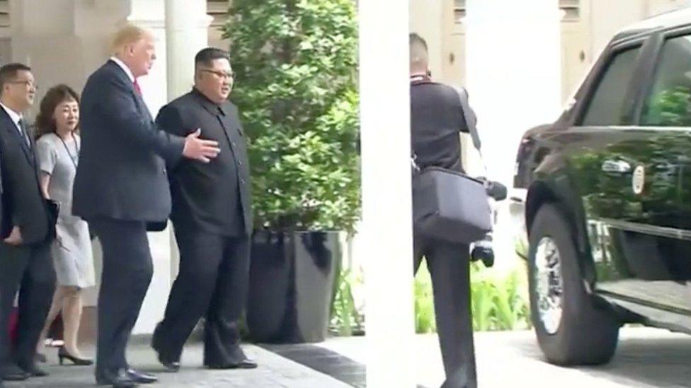 US President Donald Trump shows North Korean leader Kim Jong-un his car after a working lunch at a summit in Singapore, 12 June 2018